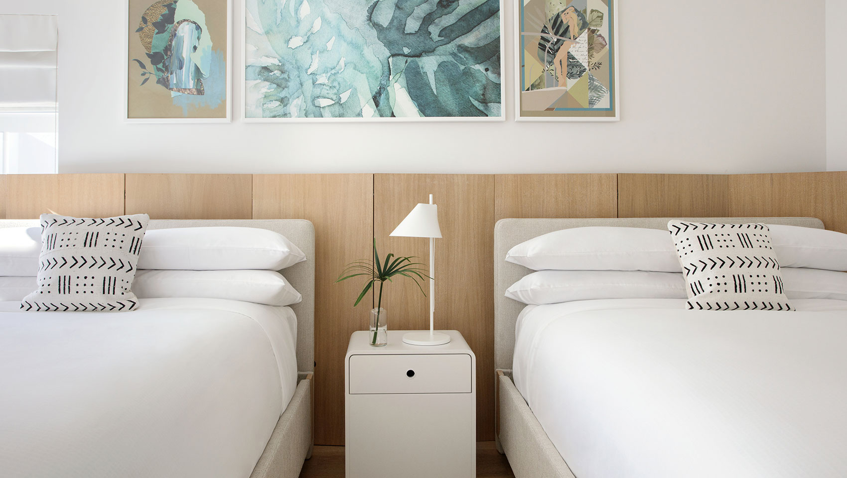 double queen room with bedside table
