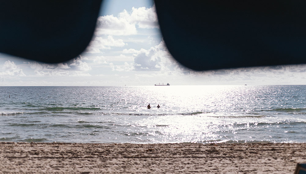 view of beach from under beach umbrella
